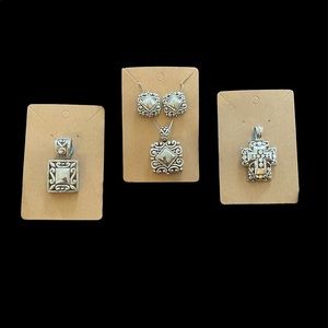 Silver tone earrings with matching pendant and two other pendants